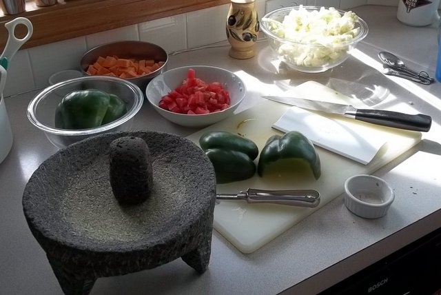 Chopping green bell pepper, carrots, tomatoes and cauliflower. Spices were crushed in an heirloom molcajete that was used by my husband's grandfather for crushing garlic and chiles.