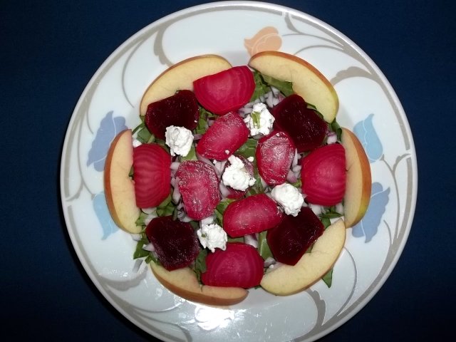 A simple summer salad of beet greens, diced red onion, Fuji apple, herbed chevre, and spiced beets.